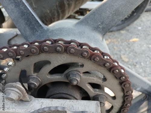 Принти на полотні Close-Up of a Rusty Drive Chain and Rear Sprocket on a Motorcycle