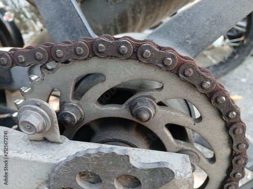 Принти на полотні Close-Up of a Rusty Drive Chain and Rear Sprocket on a Motorcycle