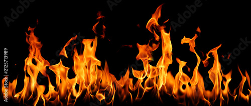 Obraz na plátně Realistic fire flames isolated on black background, featuring blazing orange fire for overlays, photo compositing, visual effects, motion graphics, heat energy and graphic design