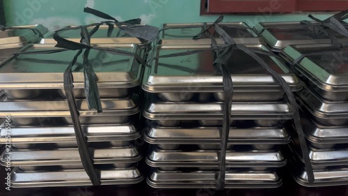 Used Food Containers Stacked and Tied After Nutritious Meal Distribution