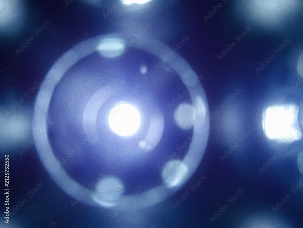 Fototapeta premium Abstract blue glowing bokeh light with circular lens flare background