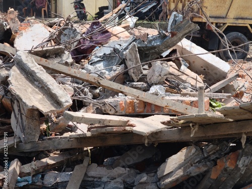 Pile of concrete rubble and twisted steel from a demolished building