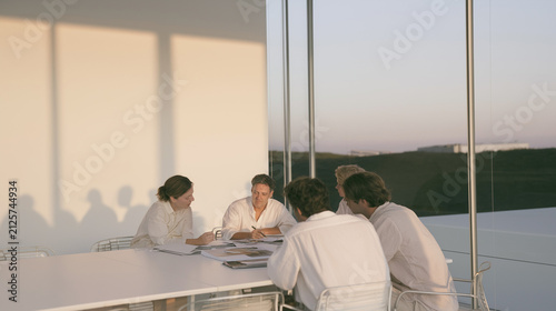 Business team meeting at a table during sunset
