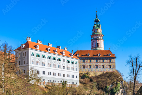 Cesky Krumlov Castle and colorful castle tower standing on cliff against blue sky, Czechia, UNESCO World Heritage Site