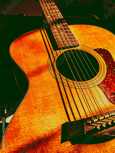 Vintage Toned Acoustic Guitar Neck and Soundhole Close-Up, Warm Orange Musical Instrument Detail
