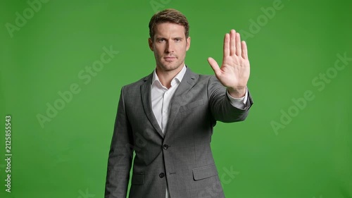 Man making stop gesture in business suit