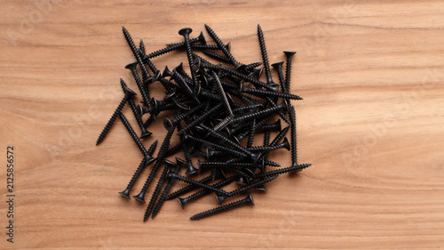 Top View Pile of Drywall Screws on Wooden Surface