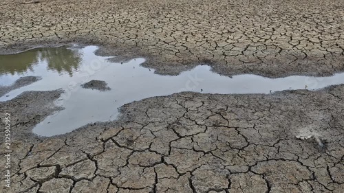 The water in a pond dries up from lack of water