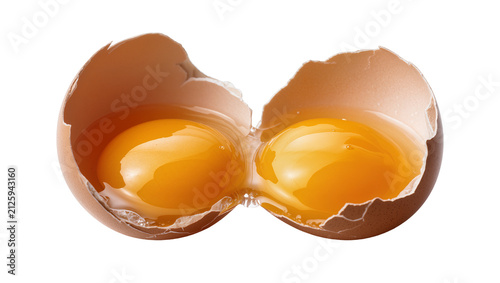 Broken brown egg with two yolks, isolated on transparent background
