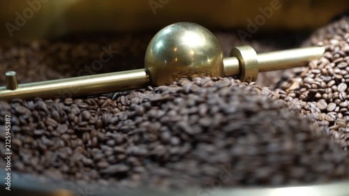 Freshly Roasted Coffee Beans: A close-up view of dark, aromatic coffee beans tumbling within a roasting machine, promising a rich and invigorating brew.
