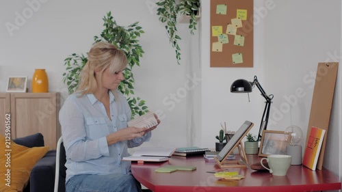 Mature businesswoman making a phone call from home office