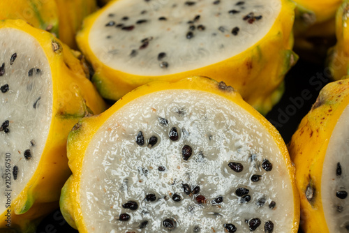 Cut ripe yellow pitahaya fruits close up view.