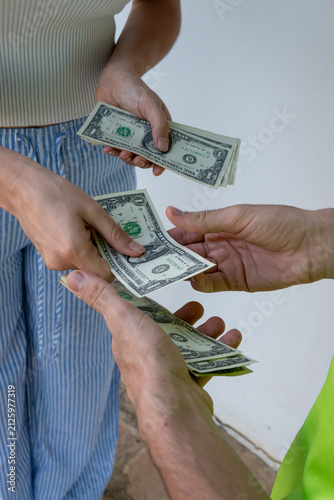 Canvas Print People's hands exchanging cash, representing concepts of payment, economy, banking, and income