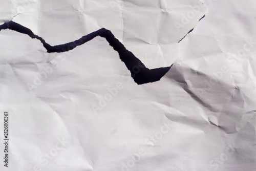 Konstfotografi Torn white crumpled paper texture background with dark shadow breakthrough concept