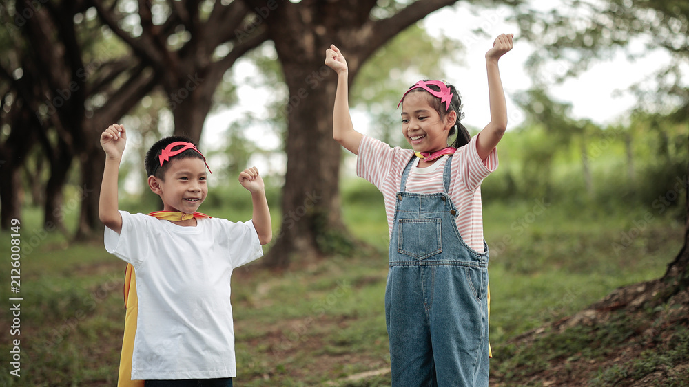 Obraz premium Happy Superhero Asian Kids Boy and Girl Power Pose Concept