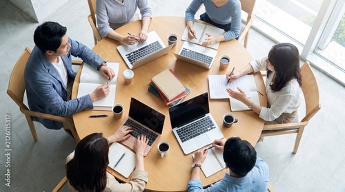 Top View of Students or Coworkers Collaborating at Round Table