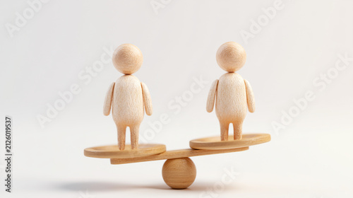 Two wooden peg human figures balancing on small seesaw scale beam

