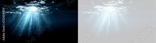 Foto Underwater sunbeams penetrating dark ocean water surface