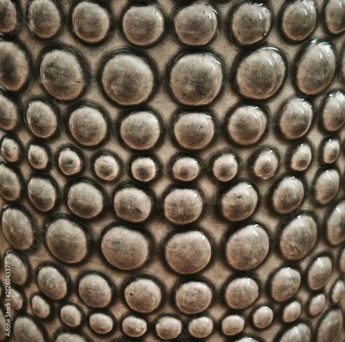 Фотография Grey ceramic surface with dimensional bubble pattern