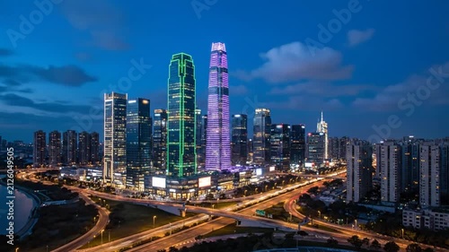 City skyline at dusk with illuminated towers.