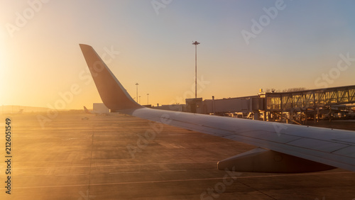 View on sunset and airplane wing from the inside
