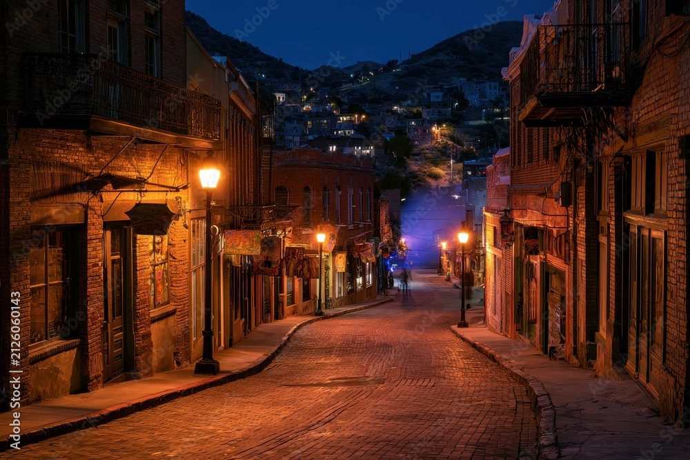 Fototapeta premium Bisbee Nightscape: Moonlit Streets, Colorful Signs, and Rustic Southwest Architecture