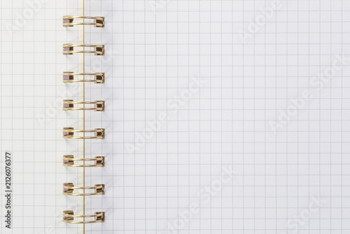 close up of sheet of exercise notebook with metallic spiral binder