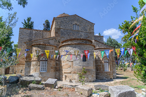 Canvastavla Carved apses and tiled dome of the Byzantine church of Panagia Skripou strung wi