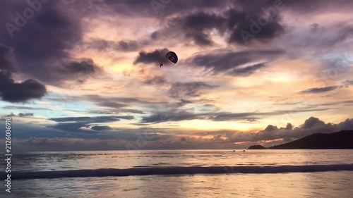 Sunset at Tropical Beach with Paragliders and Gentle Waves