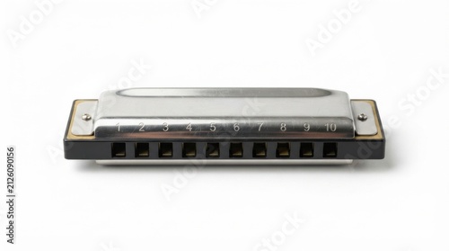 Close-up of silver harmonica on white background. Professional chromatic mouth organ for music production and performance.