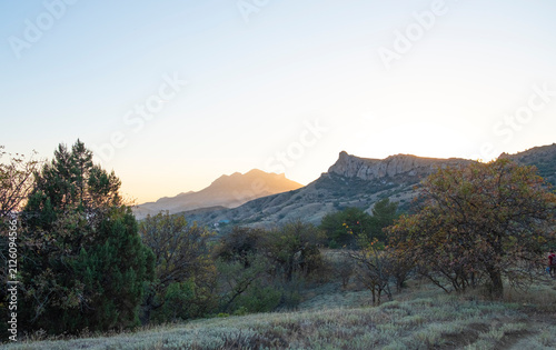 Beautiful sun rays illuminating Kara Dag, an extinct volcano in Crimea, at sunset.