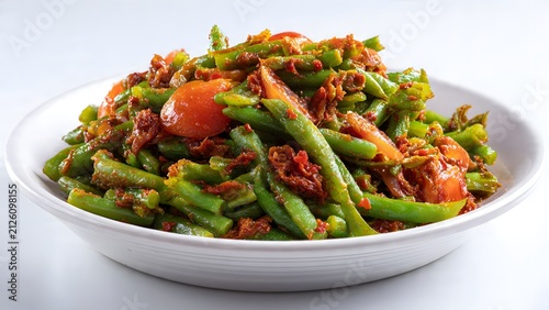 Green beans mixed with sun dried tomatoes are served in a white ceramic bowl for a healthy meal.