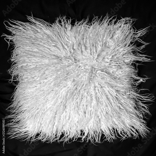 Quadro su tela A luxury shaggy faux fur fabric cushion cover in white isolated on black