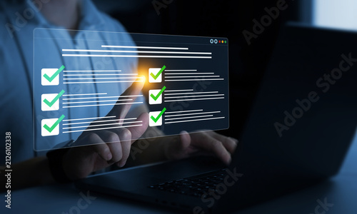 Businessman in computer doing online data documentation checklist survey. Fast checklist,clipboard task business management.Productivity checklist and filling survey form online.	
