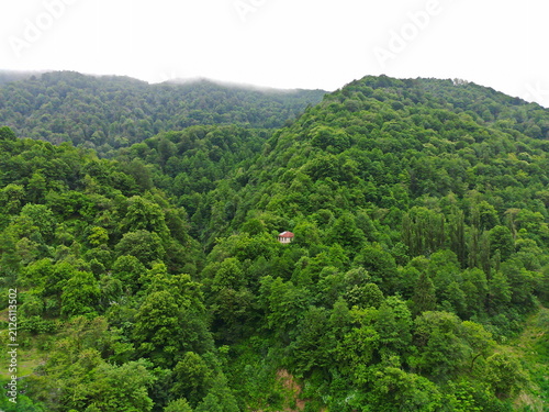 Photography A small house on a huge mountain in the Caucasian backwoods