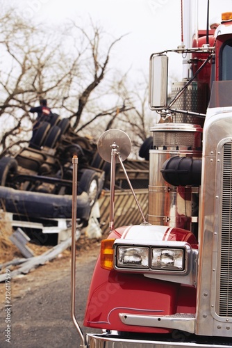 Quadro su tela Red Semi-Truck Parked Near Rolled Over Accident Vehicle on Roadside