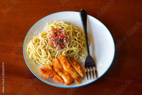 Canvastavla Aglio olio spaghetti topped with sambal matah and served with crispy chicken katsu