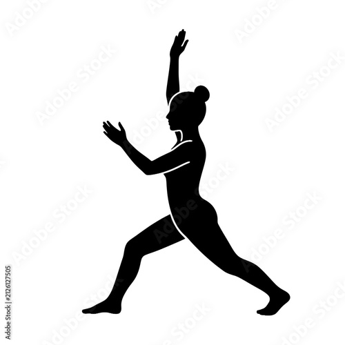 Woman practicing yoga in warrior pose silhouette