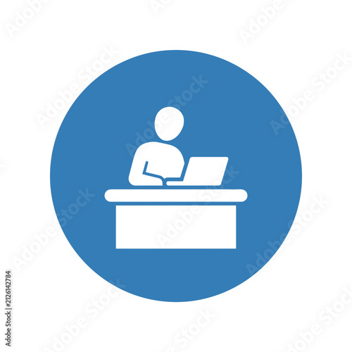 Blue and white icon representing a person working at a desk with a computer.