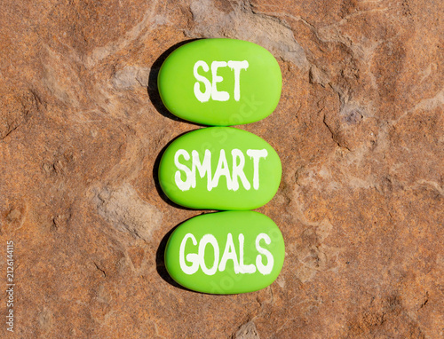 Set smart goals words symbol. Concept words Set smart goals on beautiful green stones. Beautiful stone beach background. Business and set smart goals concept. Copy space.