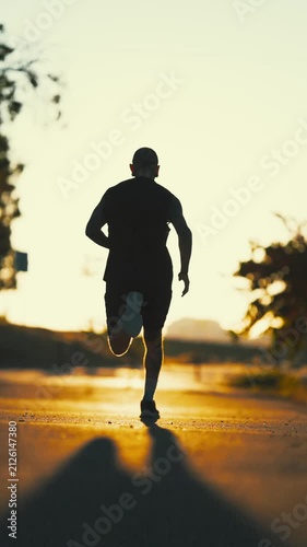 Silhouette of a man running during sunset workout