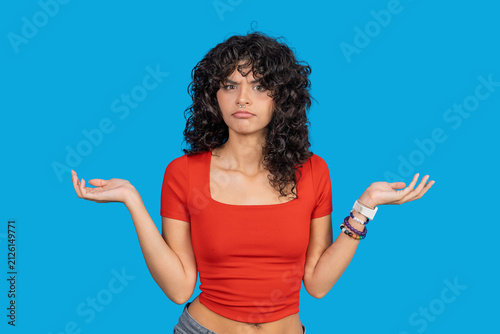 Bild auf Leinwand Young woman shrugging with confused expression experiencing uncertainty