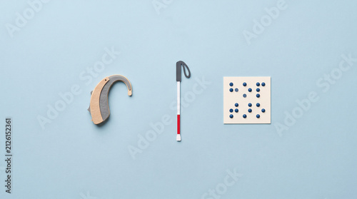 Minimalist representation representing hearing impairment visual disability and sensory aid tools for diverse inclusive communication with braille square solid light blue background