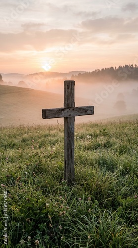 Wooden Christian Cross Standing on Grassy Hill Field During Misty Morning Sunrise