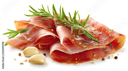 Thin slices of fresh prosciutto ham with rosemary and garlic cloves isolated on a white background