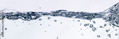 Pure water splash wave with underwater bubbles background. Real photograph, not AI-generated
