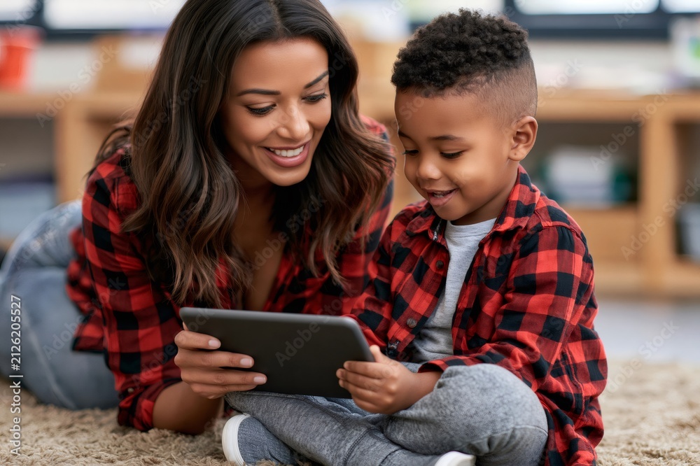 Fototapeta premium Mother and son bonding with educational tablet technology