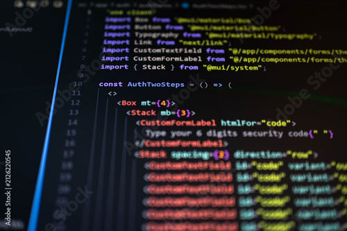 Photography Close-up of source code displayed on a computer monitor with colorful syntax highlighting and shallow depth of field, representing software development, web programming, cybersecurity, coding