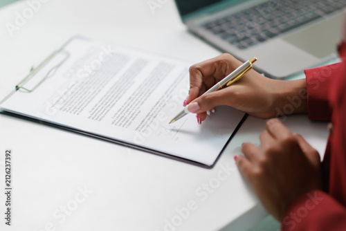 Fotografie Professional woman signing a business agreement, formalizing a legal contract wi