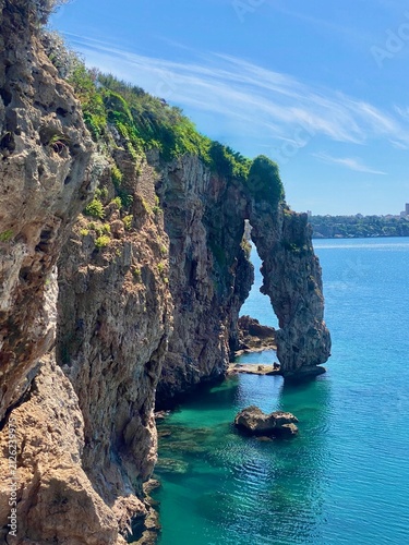 Fotografía Natural rock arch and steep cliffs over turquoise Mediterranean sea in Antalya,